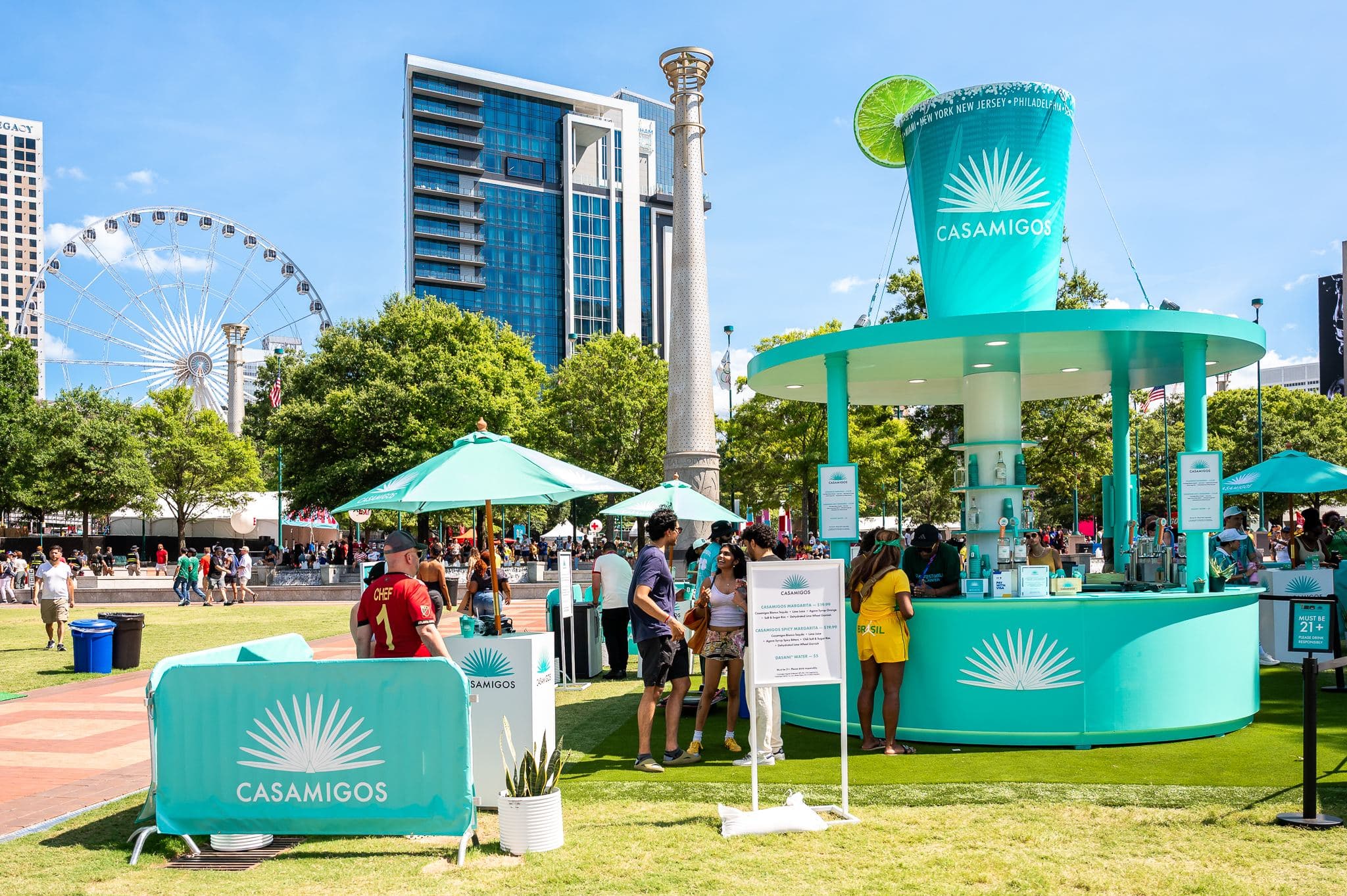 Casamigos bar with a giant margarita cup, the Atlanta skyline and Ferris wheel behind it at FIFA Fan Fest