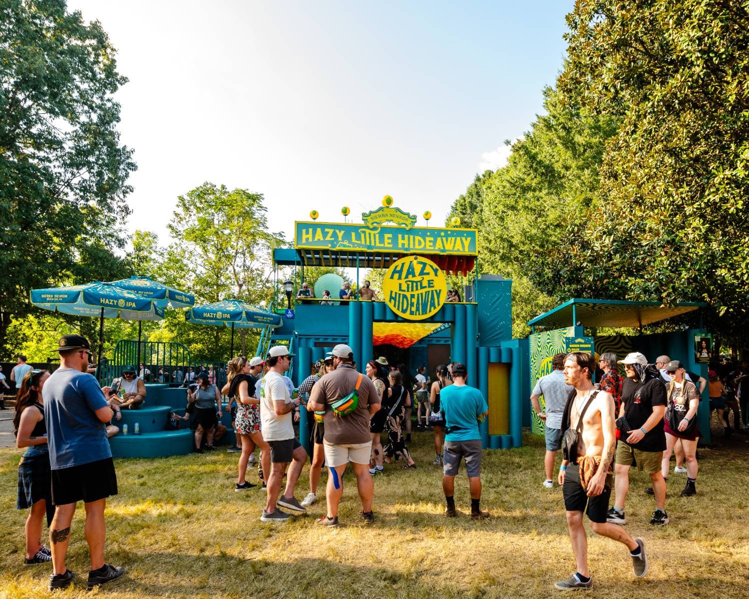 Sierra Nevada Hazy Little Hideaway two-level brand activation with a balcony and Hazy IPA umbrellas at Shaky Knees Music Festival